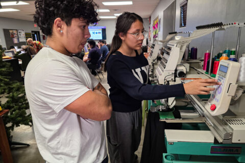 Students working with embroidery machine