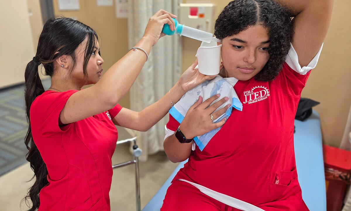 Student performing ear lavage