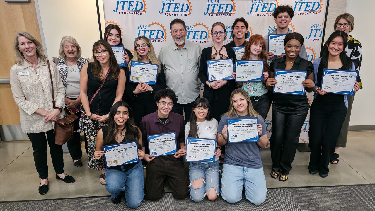 Group of students posing with certificates