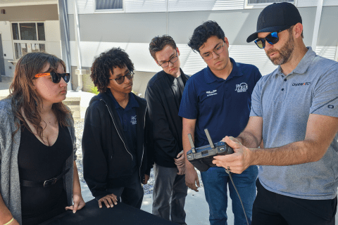 Boss showing interns drone controller