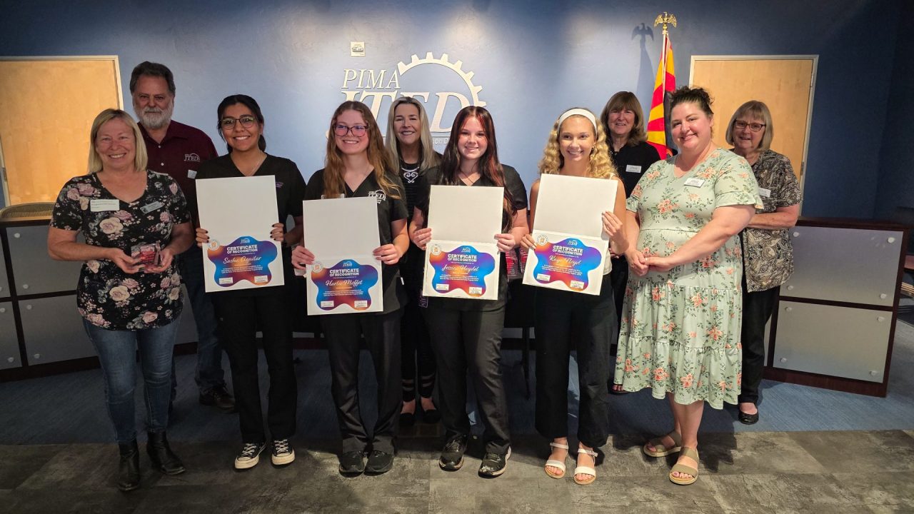 Interns and mentors posing with awards