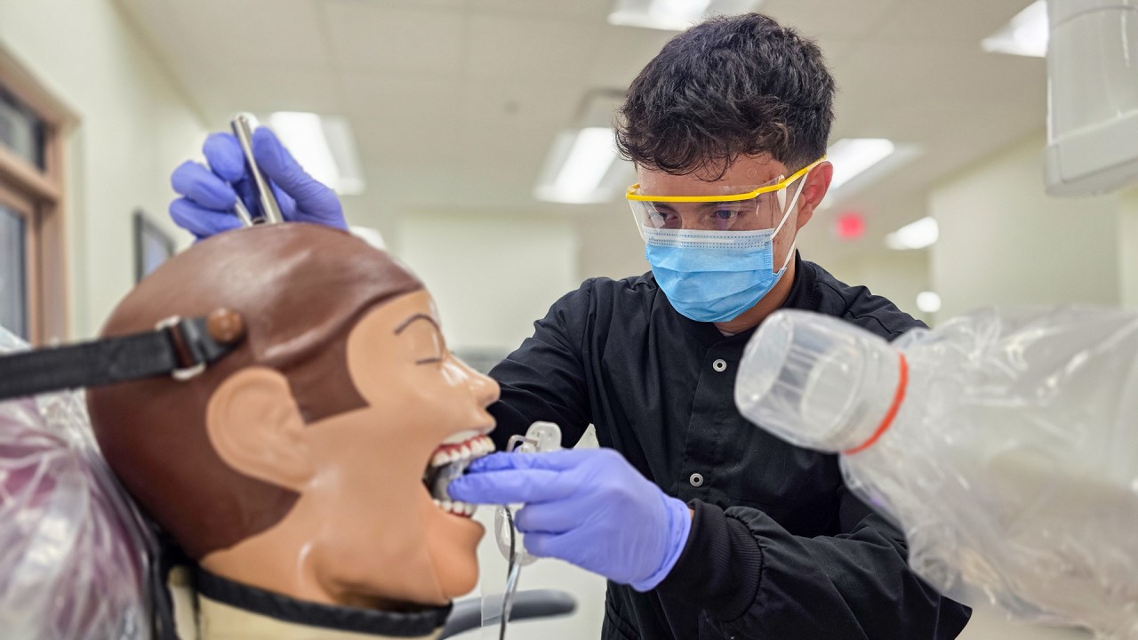 Student adjusting x-ray for teeth