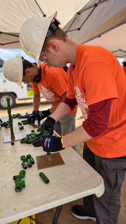 Students connecting small pipes